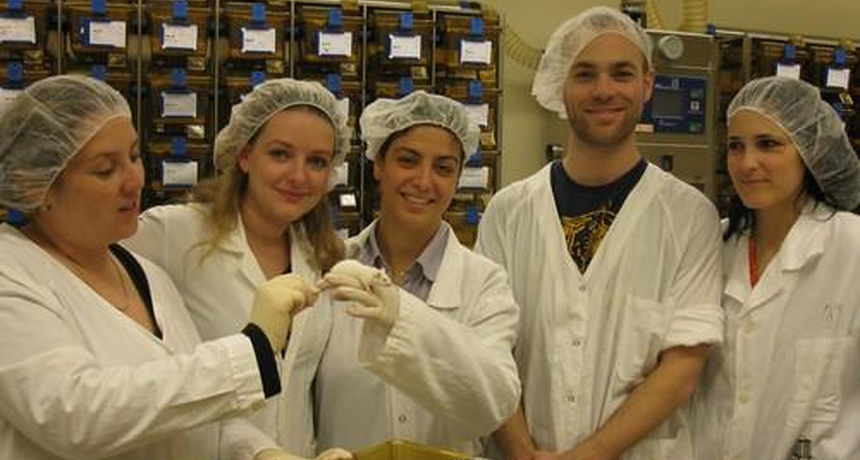 staff members holding a mouse 