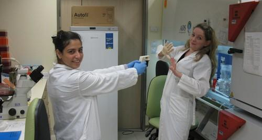 one staff member aiming a toy gun towards another staff