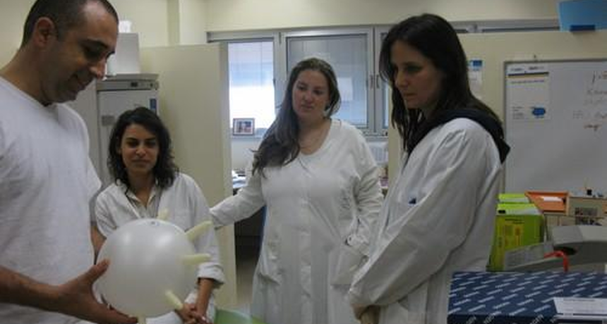 staff members with a balloon plastic glove