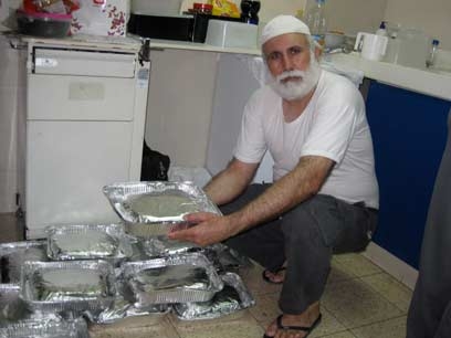 Gaza sheikh al Fara with donated tin foiled dinners for patients