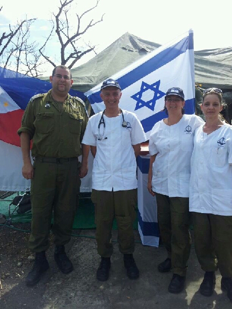 Doctors and military men stand together with the Israeli flag